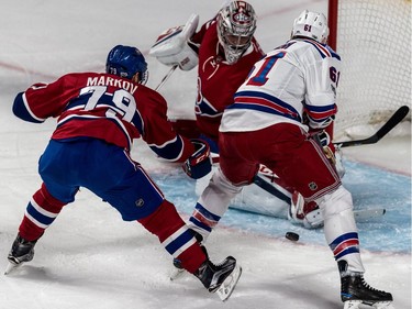 Canadiens defenceman Andrei Markov checks Rangers winger Rick Nash while goalie Carey Price makes the save Thursday night at the Bell Centre.