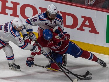 Montreal Canadiens right wing Alexander Radulov (47) is swarmed by New York Rangers defenceman Dan Girardi (5) and defenceman Marc Staal (18) during 2nd period action of game 5 of the playoffs at the Bell Centre in Montreal, on Thursday, April 20, 2017.