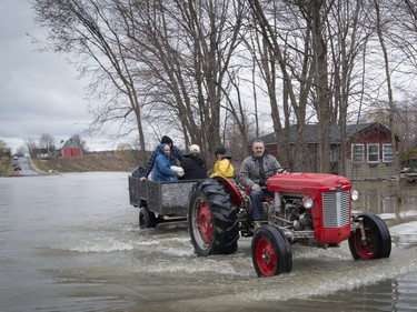 MONTREAL, QUE.: APRIL 22, 2017 --  A tractor brings residents into an area flooded by the overflowing Ottawa river in Rigaud, Quebec west of Montreal, on Saturday, April 22, 2017. (Peter McCabe / MONTREAL GAZETTE) ORG XMIT: 58488