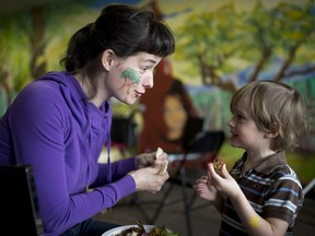 Kate Horgop and her three-year-old son Philip Peters enjoy a lunch together as they attend the Milton Earth Day Gathering across the street from Parc Leo-Pariseau in Montreal on Saturday, April 22, 2017.