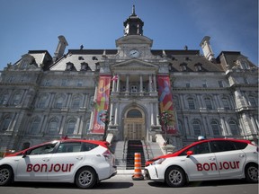 Taxis with a new look are seen outside Montreal city hall on Sunday, April 23, 2017.