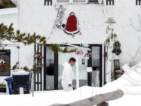 A police investigator walks past a home that is one of the murder scenes in a triple murder in Shawinigan, 120 kms northeast of Montreal Thursday April 6, 2017.  Suspect Sylvain Duquette appeared in court later in the day after being arrested at a nearby gas station.