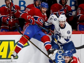 Tampa Bay Lightning Michael Bournival sends Montreal Canadiens left wing Max Pacioretty over the boards during NHL action at the Bell Centre in Montreal on Friday April 7, 2017.
