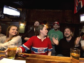 A group of Montreal Canadiens fans watch the final regular season game against the Detroit Red Wings at McLean's Pub in Montreal April 8, 2017.