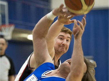 Laval Gladiators Carl Pelletier tries to block the shot of B.C. Royals Bo Hedges.