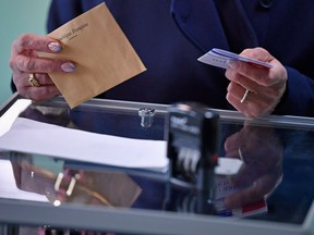 Members of the public cast their vote for the French elections in a polling station on April 23, 2017 in Henin Beaumont, France. French people go to the polls today in a tightly contested presidential election which could impact the future of the European Union