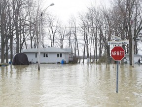 Water is shown on a residential street in the town of Rigaud, Thursday, April 20, 2017.