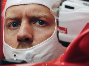 German driver Sebastian Vettel looks from the cockpit of his Ferrari at the Shanghai International Circuit on Friday.