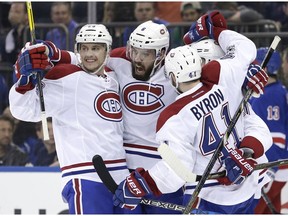 Canadiens' Shea Weber, centre, celebrates with teammates after scoring during the third period in Game 3 of an NHL hockey first-round playoff series against the New York Rangers on Sunday, April 16, 2017, in New York.