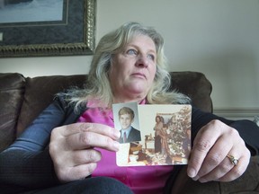 Sandra Stewart holds photos of her late brother, John Michael Stewart. She recently contacted the SQ to inquire about what happened with their investigation into her brother's murder, and hopes the file will be reopened as a cold case.