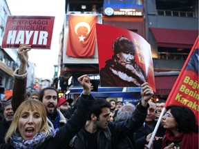 Supporters of the 'no' vote, (Hayir in Turkish) one holding a banner of modern Turkey's founder Mustafa Kemal Ataturk, chant slogans during a protest against the referendum outcome, in Istanbul, Tuesday, April 18, 2017. Hundreds of people are queuing in front of Turkey's election board in capital Ankara to submit petitions requesting that the electoral authority reverse a controversial decision during Sunday's referendum to accept ballots without official stamps, as required by Turkish law.