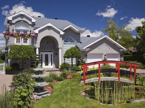 The facade of the house is landscaped with lots of trees clipped into ornamental shapes and a small koi pond which are all meticulously cared for by the owner.