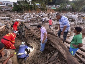 Rescuers search for people among the rubble left by a mudslide following heavy rains in Mocoa, Putumayo department, southern Colombia on April 1, 2017.