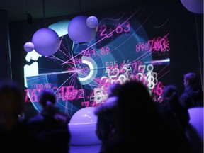 Visitors watch projections at the CERN, the European Organization for Nuclear Research, in 2011. Almost 100 years before, Ernest Rutherford gave a lecture at McGill outlining the progress being made in unravelling the secrets of the atom.