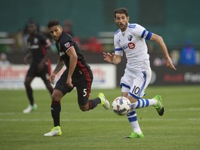 D.C. United defender Sean Franklin (5) battles for the ball against Montreal Impact midfielder Ignacio Piatti (10) at Robert F. Kennedy Memorial.