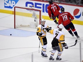 Pittsburgh Penguins center Jake Guentzel (59) celebrates his empty-net goal with Matt Cullen (7) as Washington Capitals center Nicklas Backstrom (19), of Sweden, and T.J. Oshie skate away during the third period of Game 2 in an NHL hockey Stanley Cup second-round playoff series, Saturday, April 29, 2017, in Washington. (AP Photo/Nick Wass)