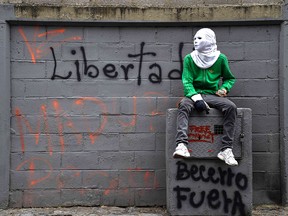 Photo of the day: A Venezuelan opposition activist sits against a wall reading "Freedom!" during a protest against President Nicolas Maduro, in Caracas May 8, 2017.