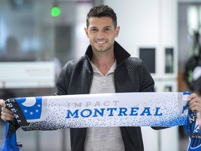 Swiss international midfielder Blerim Dzemaili shows off the colours of his new team, the Montreal Impact, upon arriving at the Montreal Trudeau Airport Tuesday, May 9, 2017 in Montreal.