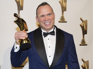 Dave Morissette holds up his ward for best sports show host at the Gala Artis awards ceremony in Montreal, Sunday, May 14, 2017.