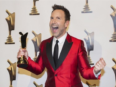 Eric Salvail holds up his ward for best talk show host at the Gala Artis awards ceremony in Montreal, Sunday, May 14, 2017.