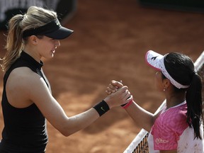 Eugenie Bouchard, left, is congratulated by Japan's Risa Ozaki after Bouchard won the first round match in three sets 2-6, 6-3, 6-2, at the French Open tennis tournament at the Roland Garros stadium in Paris, France, Tuesday, May 30, 2017.