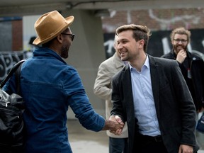 "I think there's a real appetite for a new political voice, a new political movement," says Gabriel Nadeau-Dubois, seen greeting Angelo Cadet at the Beaubien métro station on Tuesday.