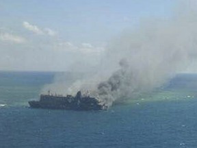 In this aerial photo released by Indonesian Search And Rescue Agency (BASARNAS), thick smoke billows from passenger ferry Mutiara Sentosa 1 which caught fire in Java Sea Saturday, May 20, 2017. The ferry caught fire Friday evening leaving a number of people dead and hundreds others rescued, Indonesian authorities said Saturday. (BASARNAS via AP)