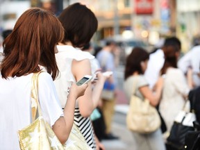 People use their smartphones on July 16, 2014 in Tokyo, Japan. The diabolically devious thing about cellphones is that most people seem not to have the faintest idea of any negative effect, Pierre Home-Douglas writes.
