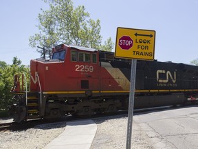 CN engines pull freight wagons and containers over a level crossing in Barrington, Ill., in 2015.