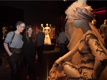 Gaelle Leroyer (left) and Frédérique Blache-Pichette admire a piece at The Fashion World of Jean Paul Gaultier at the Montreal Museum of Fine Arts in 2011. (Michelle Berg / THE GAZETTE)