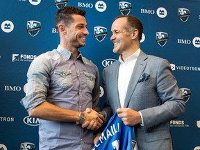 Montreal Impact designated player Blerim Dzemaili, left, shakes hands with president Joey Saputo after the team introduced Dzemaili to the media in Montreal on Thursday May 11, 2017.