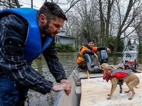 Residents of Île-Mercier, like Stéphane Jacob and his chihuahua Bibi, keep it safe by wearing life jackets on Thursday, May 11, 2017.