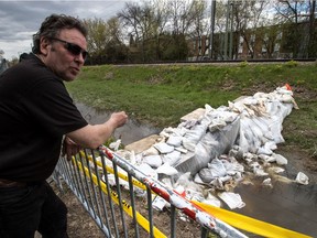 Now that a small dike was constructed between a city bike path and the AMT train tracks, the area around 5th Ave. N. and Gouin Blvd. is completely dry in Pierrefonds-Roxboro, on Friday, May 12, 2017. Jeff Arsenault is one of the owners whose home was under water due to the decision by the AMT to not allow anyone on their land. Once the dam was built the streets were drained in three hours.