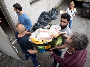 Volunteers form a human chain to load a truck with food and toiletries during the West Island Community Shares food drive for flood victims on Saturday.