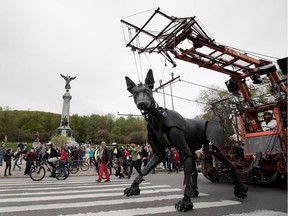 A huge dog puppet makes its way down Park Ave. in Montreal on Friday May 19, 2017.