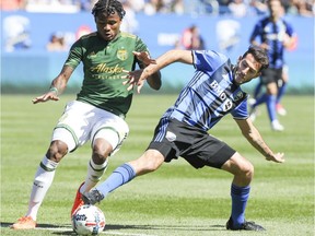 Montreal Impact's Ignacio Piatti pulls the ball away from Portland Timbers Alvas Powell during first half of MLS game in Montreal on Saturday May 20, 2017.