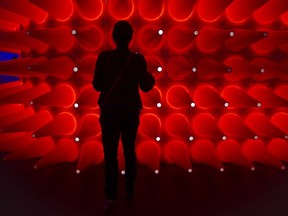 A visitor looks at an exhibition at the 2012 edition of C2 Montreal, a creative marketing and networking event.