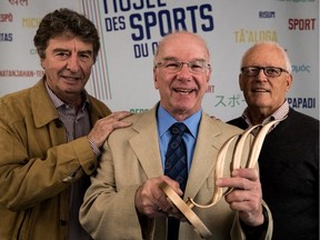 The Quebec Sports Hall of Fame named its 14 new members during a news conference at the Olympic Stadium in Montreal, on Tuesday, May 23, 2017. Members François Godbout, left, and Claude Raymond, right, were on hand to welcome new member Donald Dion to the club.