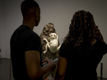 Visitors examine an artwork by Valerie Blass at the Musée d'art contemporain de Montreal during Montreal Museums Day on Sunday, May 28, 2017.