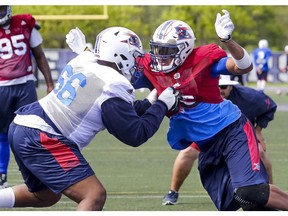 Defensive-end John Bowman, right, goes one-on-one with offensive lineman Brian Simmons during Alouettes training camp at Bishop's University in Lennoxville on Tuesday May 30, 2017.