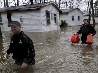 The flooding continues on Île Mercier, off Île Bizard on Friday, May 5, 2017. Wading through near waste-deep waters is one way of getting about on the island.