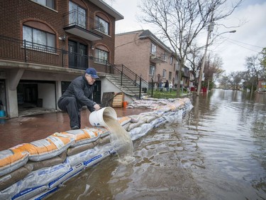 Gianni Crivello works to keep water from his basement on Cousineau St. in the Cartierville Ahuntsic borough of Montreal on Sunday, May 7, 2017.