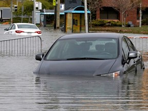 MONTREAL, QUE.: MAY 8, 2017 -- Cars are stranded in the middle of Rue Rene-Emard next to Pierrefonds Comprehensive High School in Pierrefonds, on Monday, May 8, 2017. (Dave Sidaway / MONTREAL GAZETTE) ORG XMIT: 58576