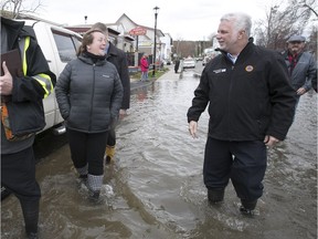 Quebec Premier Philippe Couillard talks to local resident of Oka, during impromptu tour of the flooded town on Tuesday May 9, 2017. (Pierre Obendrauf / MONTREAL GAZETTE)