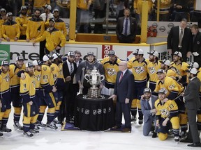 Nashville Predators players and coaches pose with NHL Deputy Commissioner Bill Daly and the Campbell Bowl after winning Game 6 of the Western Conference final against the Anaheim Ducks in the NHL hockey Stanley Cup playoffs Monday, May 22, 2017, in Nashville, Tenn. The Predators, the final team into the NHL playoffs, are headed to the first Stanley Cup Final in franchise history.