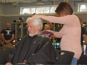 Hairdresser Tanya Gauthier gives Dave Croydon a final trim after snipping off his foot-long pony-tail. (courtesy photo by Charles Taylor)