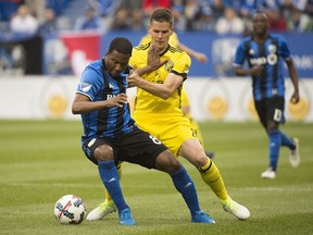 Impact's Patrice Bernier, left, holds off a challenge by Columbus Crew's Jukka Raitala during second half MLS soccer action in Montreal, Saturday, May 13, 2017.