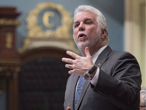 Quebec Premier Philippe Couillard responds to Opposition questions over former premier Jean Charest and Marc Bibeau, during question period Tuesday, April 25, 2017 at the legislature in Quebec City. Couillard says he is ruling out a snap provincial election.
