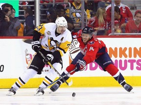 WASHINGTON, DC - MAY 06: Evgeni Malkin #71 of the Pittsburgh Penguins moves around John Carlson #74 of the Washington Capitals during the third period in Game Five of the Eastern Conference Second Round during the 2017 NHL Stanley Cup Playoffs at the Verizon Center on May 6, 2017 in Washington, DC. The Capitals defeated the Penguins 4-2.