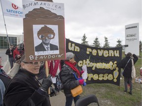 Protesters demonstrate in front of the Bombardier finishing plant as the company holds its annual meeting May 11, 2017, in Montreal.